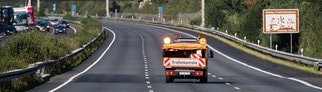 Fahrzeug der Autobahnmeisterei fährt über die gesperrte Autobahn