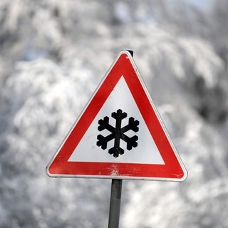 Straßenschild: Warnung vor winterlichen Straßenverhältnissen – Nach dem Schneechaos am Wochenende wird es jetzt auf den Straßen glatt.