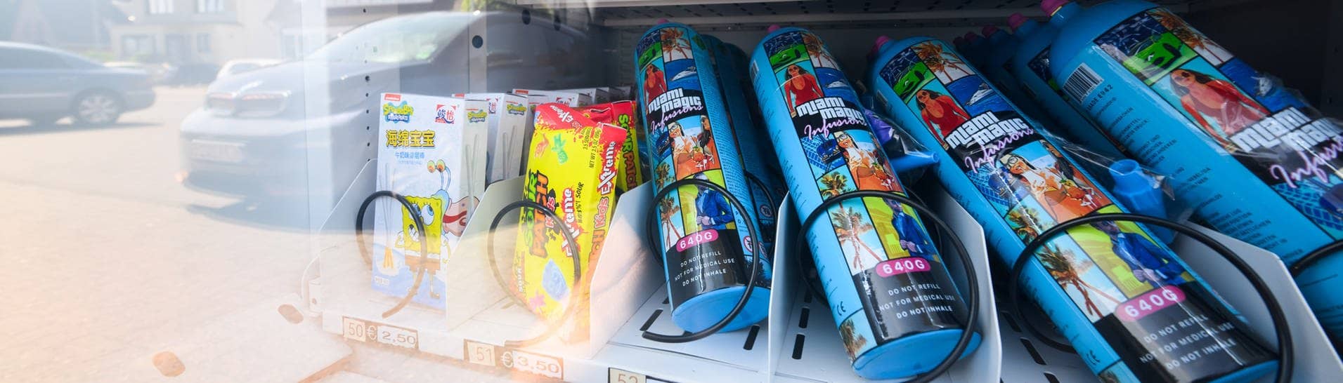 Kartuschen mit Lachgas werden in einem Automaten zum Kauf angeboten, neben Süßigkeiten.