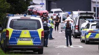 Polizisten stehen an einer Straße bei einem Einsatz in Albstadt-Lautlingen. Bei einem Großeinsatz in Albstadt auf der Schwäbischen Alb haben Polizisten drei Tote und zwei Verletzte gefunden.