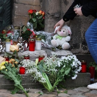 Blumen, Kerzen und Kuscheltiere auf dem Weihnachtsmarkt in Magdeburg für die Opfer des Anschlags