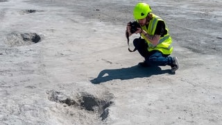 Eindrucksvolle Spuren: 166 Millionen alte Dinosaurier-Fußabdrücke in einem Steinbruch in England gefunden. Wissenschaftler fotografiert einen Fußabdruck.