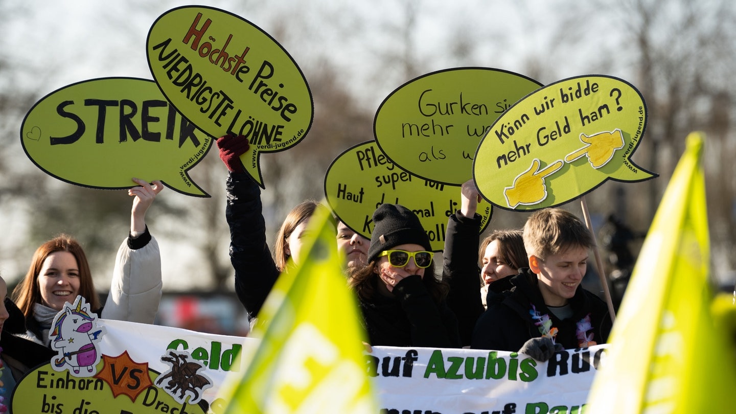 Teilnehmer beim Jugendstreiktag 2023 halten verschiedene Plakate in die Höhe.