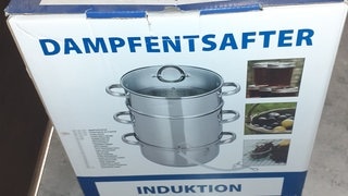 Verpackungskarton zeigt Bild eines Dampfentsafters.