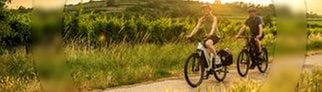 Ein Mann und eine Frau fahren auf den E-Bikes aus dem SWR3 Gewinnspiel der SWR3 E-Bike-Challenge durch SWR3Land und genießen den Frühling.