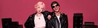 Bruno Mars und Rosé stehen gemeinsam vor Lautsprecherboxen und haben einen Song namens APT.