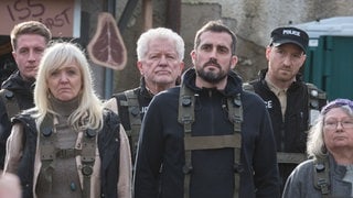 Tatort Müchen Charlie: Zwischen den COB stehen Hauptkommissar Ivo Batic (Miroslav Nemec, Mitte hinten) und Maximilian Frei (Lukas Turtur, hinten rechts) beim Appell und hören der Rede vom COB-Chef, Wayne Jameson (Milton Welsh), zu. 